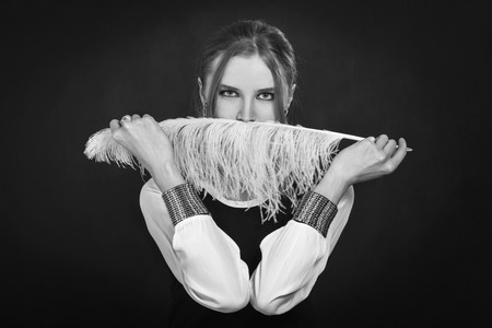 woman cover her face with feather, monochrome