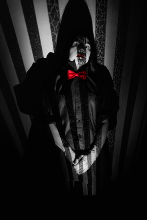 scared girl in black shirt in darkの写真素材