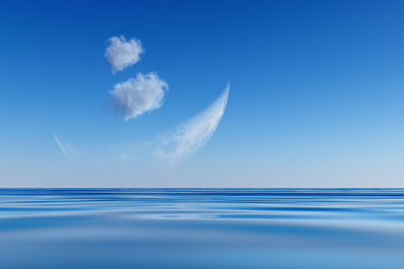 blue crescent and clouds over seaの写真素材