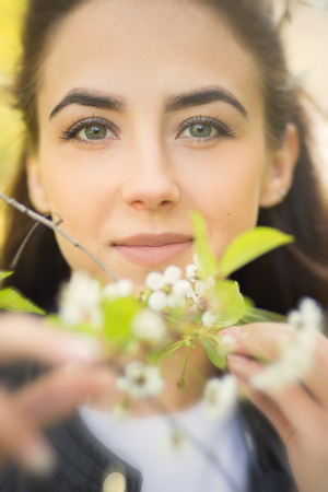 sensual young woman in cherry flowers, blurred imageの写真素材