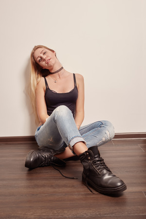 sad pensive girl sitting on floorの写真素材