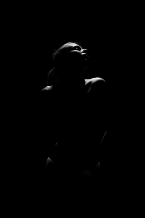 sensual aroused woman in dark, monochrome imageの写真素材