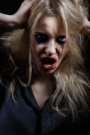 bloody witch screaming in darkの写真素材