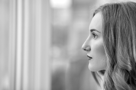 serious young woman profile with copyspace, monochromeの写真素材