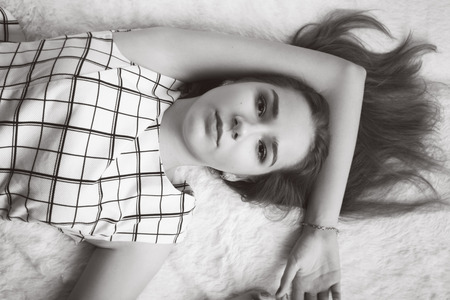 sensual woman lying on fur, monochrome imageの写真素材