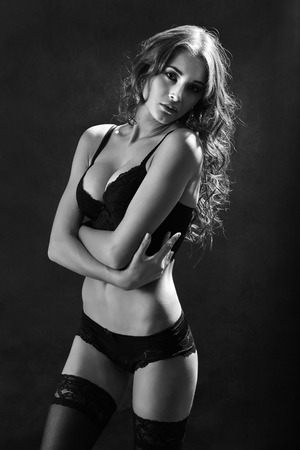 attractive tan woman in lingerie and stockings, monochrome imageの写真素材