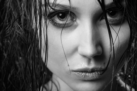 beautiful woman with wet hair looking at camera, monochrome imageの写真素材