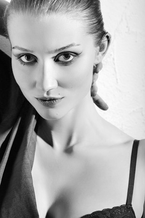 sensual young woman on white wall background, monochromeの写真素材
