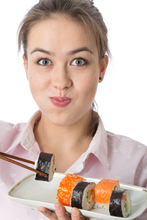 young woman with sushi smiling on white backgroundの写真素材