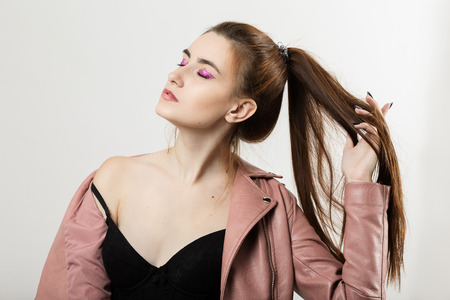 pretty woman with long hair posing on white backgroundの写真素材