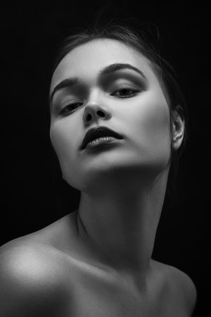 happy luxury woman model with professional makeup on black background, monochromeの写真素材