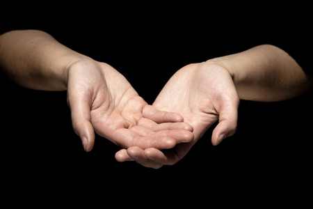 hands in mudra gesture on black backgroundの写真素材