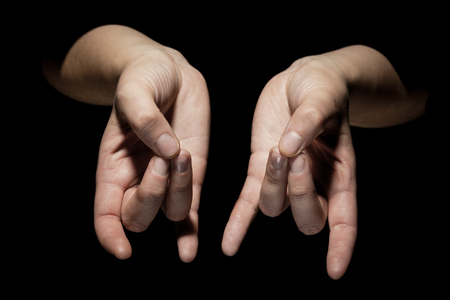 hands in mudra gesture on black backgroundの写真素材
