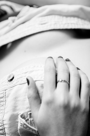 unrecognizable sensual young female decollete with hand closeup, monochromeの写真素材