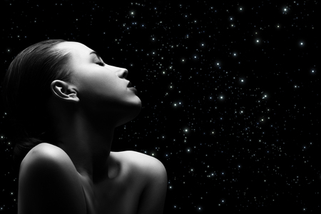 Sensual aroused woman with closed eyes on stars background, monochromeの写真素材