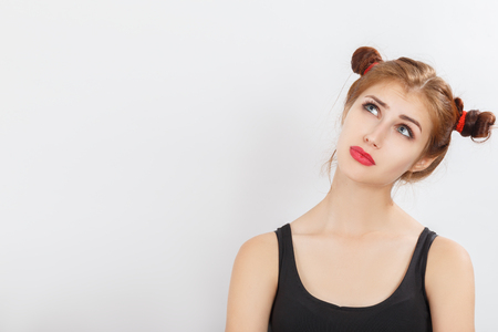 fun girl on white background with copy space dreaming looking upの写真素材