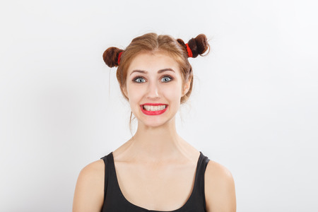 fun happy girl on white background smiling looking at cameraの写真素材