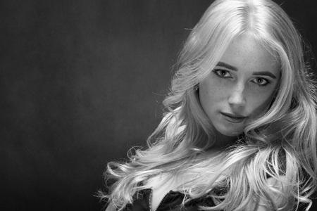 sensual sad blond woman with freckles portrait on black, monochromeの写真素材
