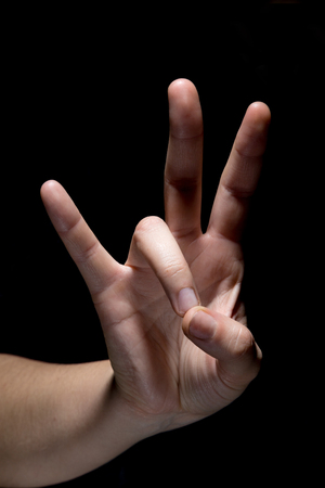 hand in mudra gesture position on black backgroundの写真素材