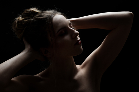 sensual woman, closed eyes on black backgroundの写真素材