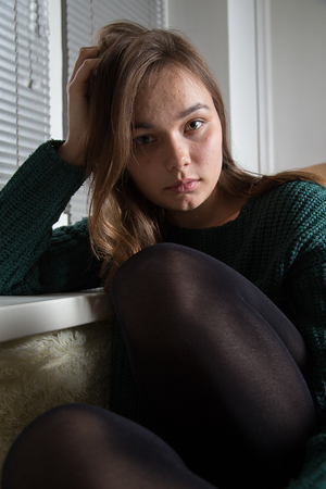 sad pensive young woman looking at cameraの写真素材