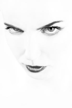 serious woman with a natural beauty makeup look on a white background looking at camera, monochromeの写真素材