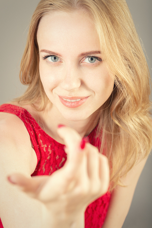 beautiful young woman point at camera smilingの写真素材