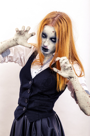 zombie girl attack with yellow hair in attack pose on white backgroundの写真素材