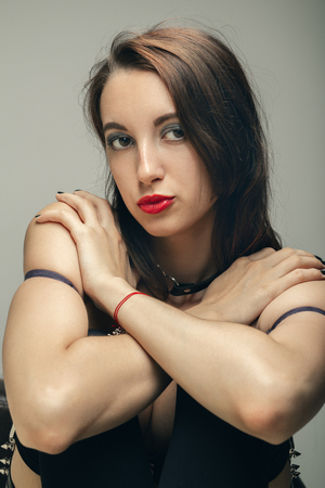 sensual beautiful young woman in lingerie cover her bare body, looking at cameraの写真素材