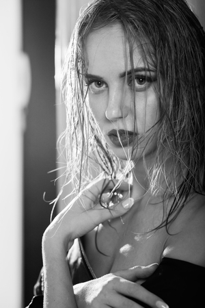 sensual bare blond girl in leather jacket looking at camera, monochromeの写真素材