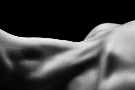 beautiful female slim neck with clavicle on black background, monochromeの写真素材