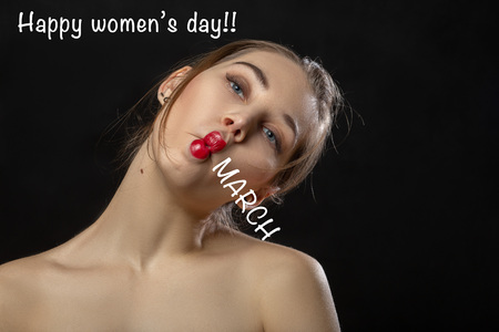 fun woman face grimacing making 8 march with lips on black background with happy women's day...