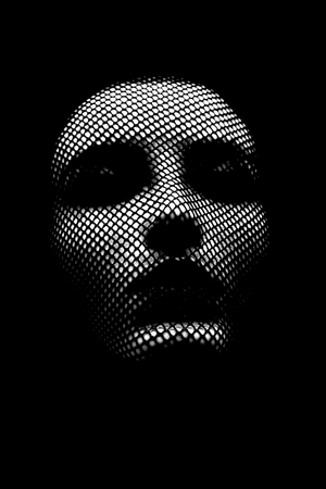 serious female beautiful face with stocking on head, black background, closed eyesの写真素材