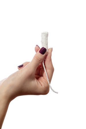young female hand with tampon isolated on white backgroundの写真素材