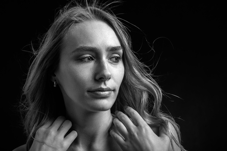 serious sensual blond transgender on black background looking aside, monochromeの写真素材