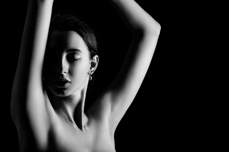 sensual girl on black background with copy space, monochromeの写真素材