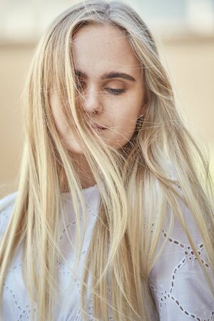 attractive blond girl with freckles looking at cameraの写真素材