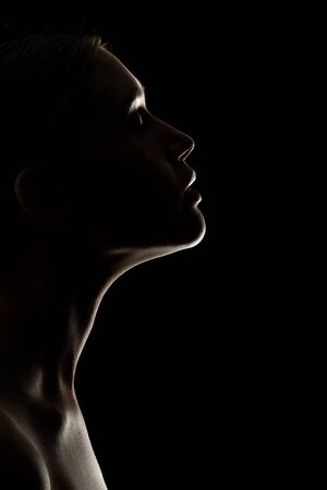 profile of young sensual woman with closed eyes on black backgroundの写真素材