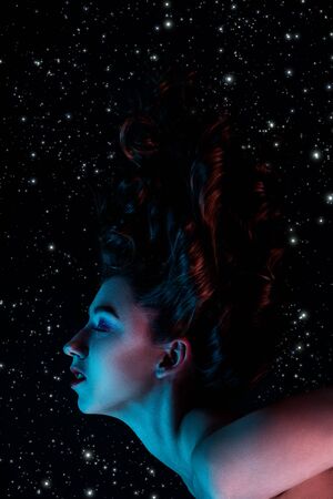 witch flying in moonlight on stars background, profile side viewの写真素材