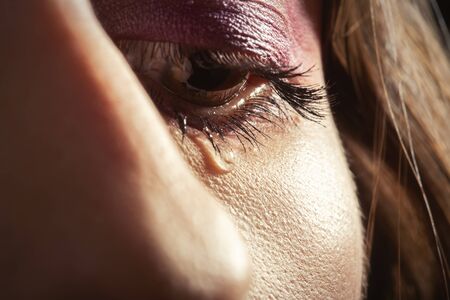 sad woman crying, tear on eye closeup portrait