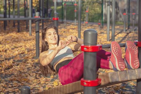 young sports woman does gymnastics on the autumn sports ground