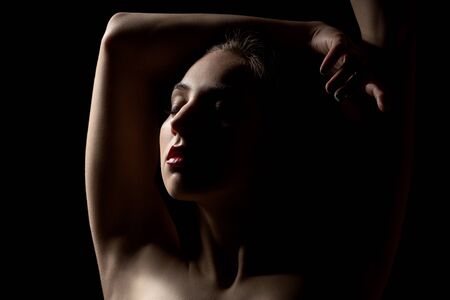 sensual woman, closed eyes on black backgroundの写真素材