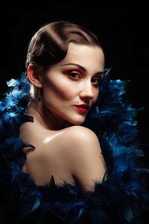 young luxury woman in retro vintage style on black background looking at camera