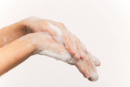 woman washing her hands closeup side view on white background