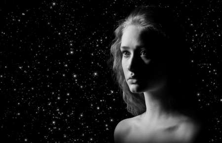 sad girl with bared shoulders on stars background, monochromeの写真素材