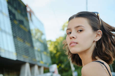 young attractive woman at city looking at camera closeup portrait