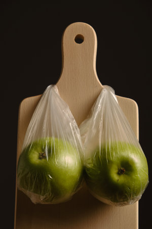 two green apples on wooden board closeupの写真素材