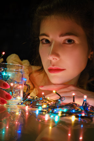 young luxury woman with christmas multicolor led garland closeup portrait