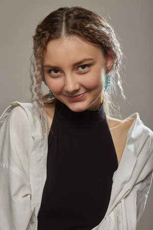 happy blond young woman with curly hair looking at camera smiling