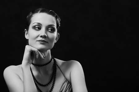 young luxury woman in retro vintage style on black background with copy space, monochromeの写真素材